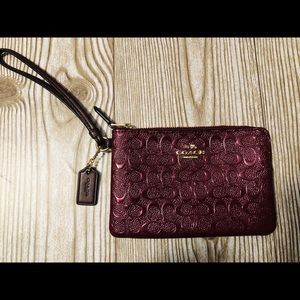 Small burgundy Coach wristlet